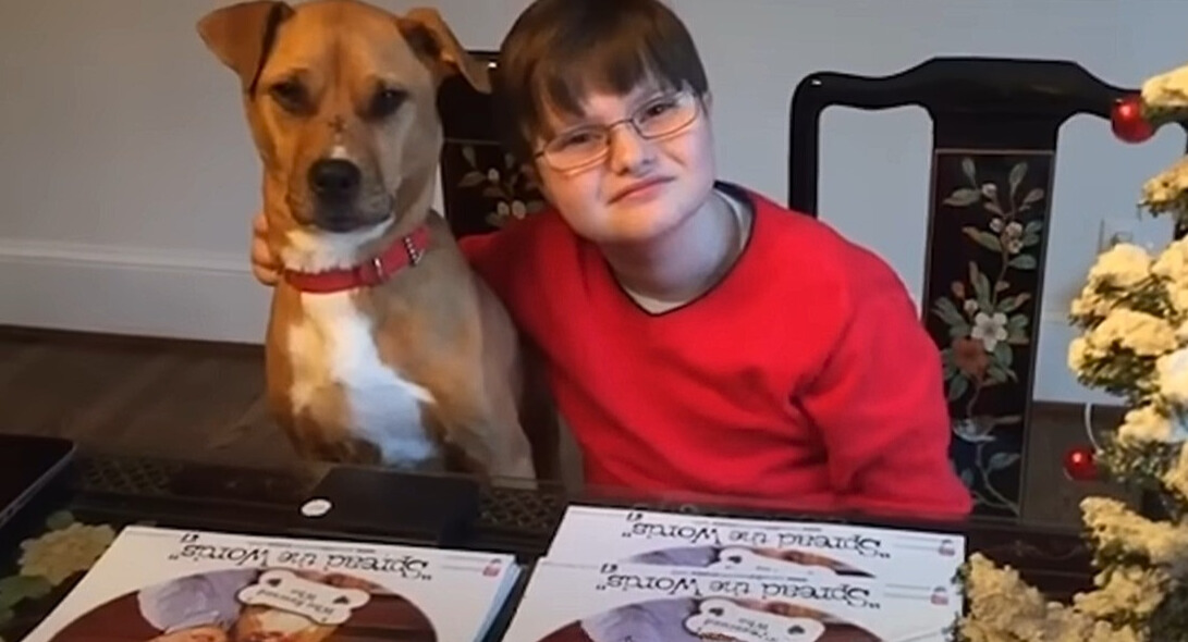 little boy with dog by the table