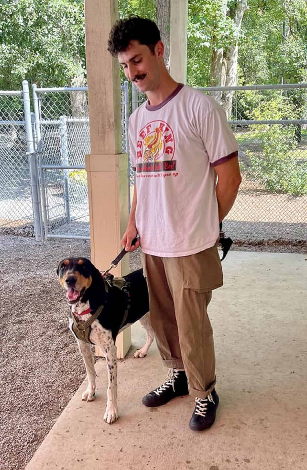 man holding dog on a leash after reunion