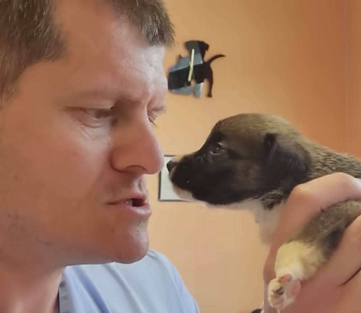 man holding puppy