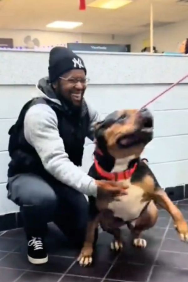 man hugging his dog