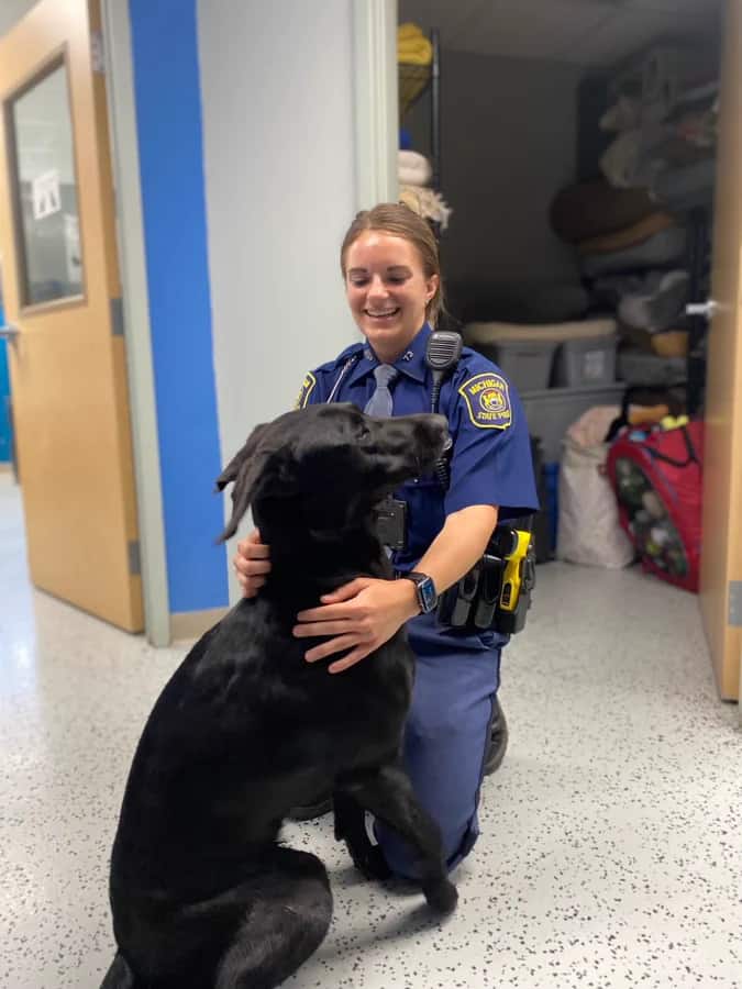 trooper petting the dog at the shelter