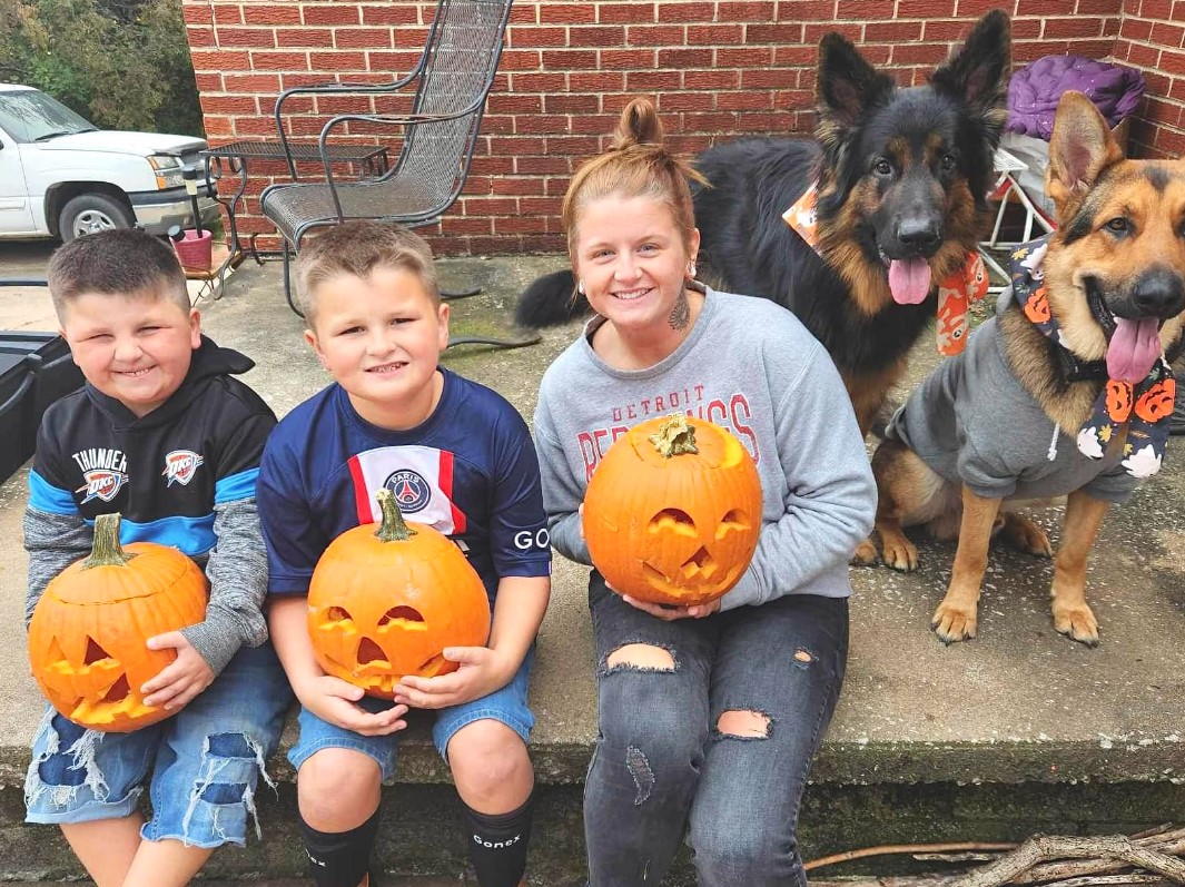 two boys and a girl with two dogs