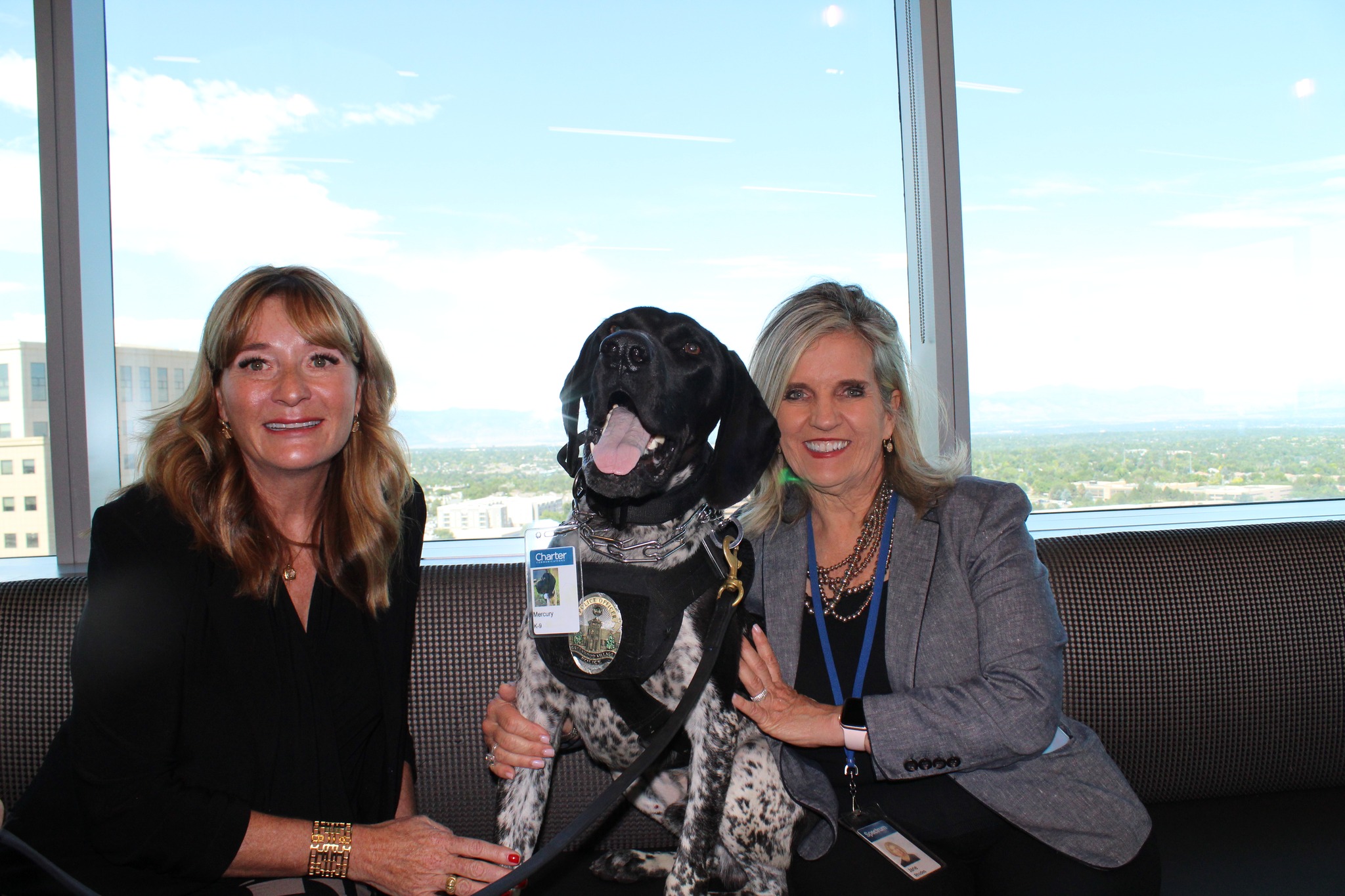 two woman and hero police dog