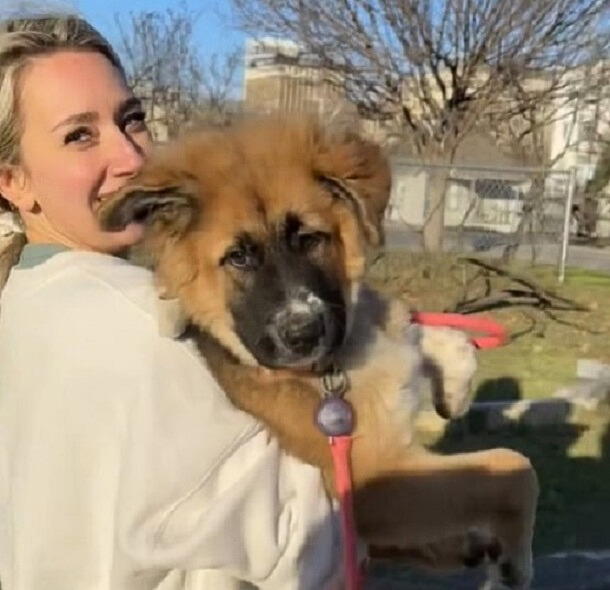 woman holding a big dog