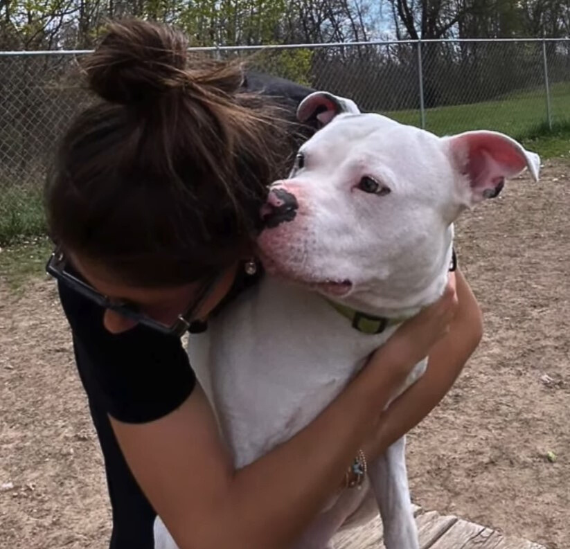 woman hugging with happy dog