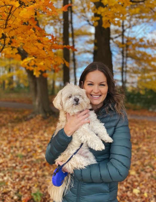 smiling girl in autumn park with dog