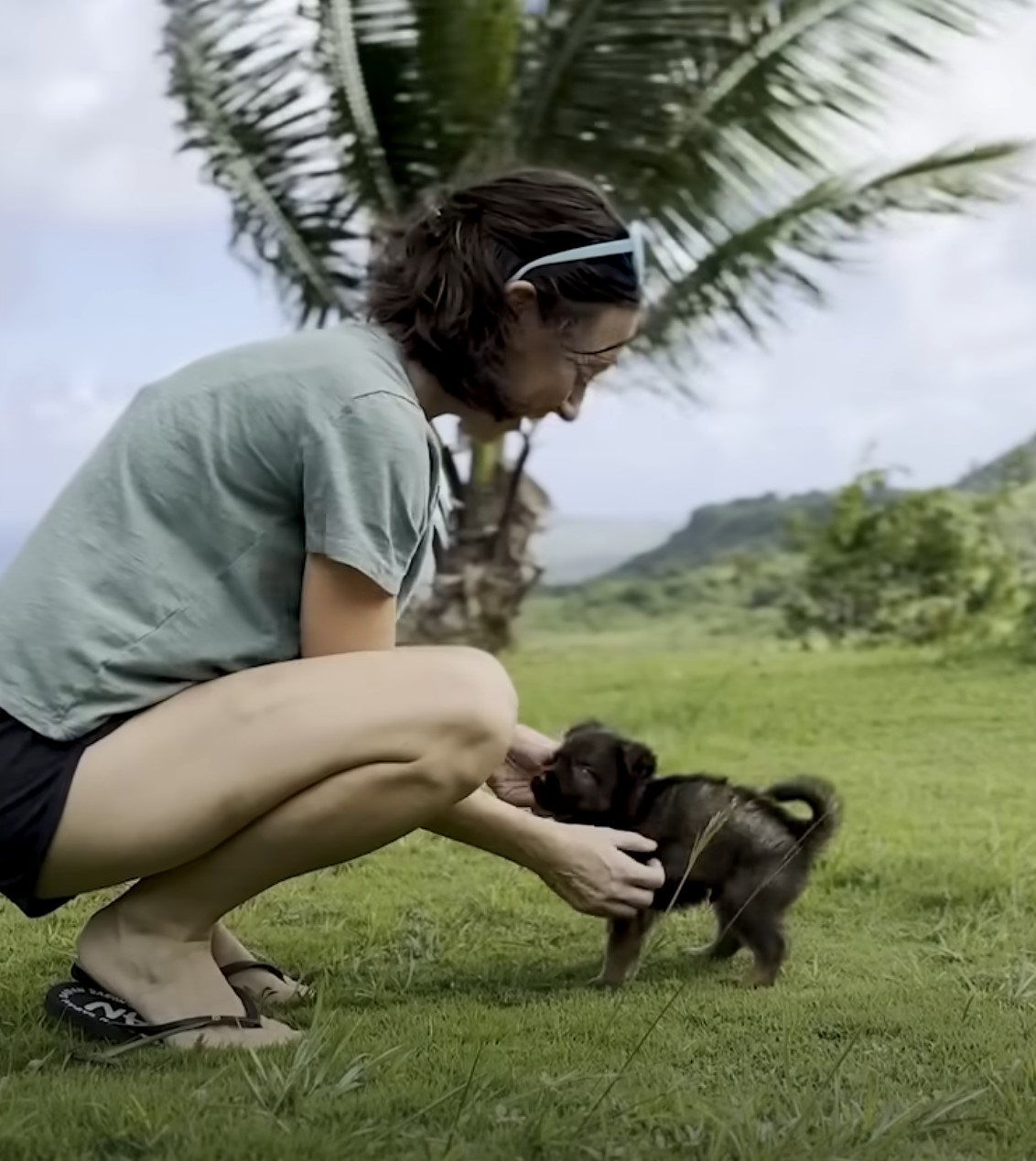 woman and sweet black puppy