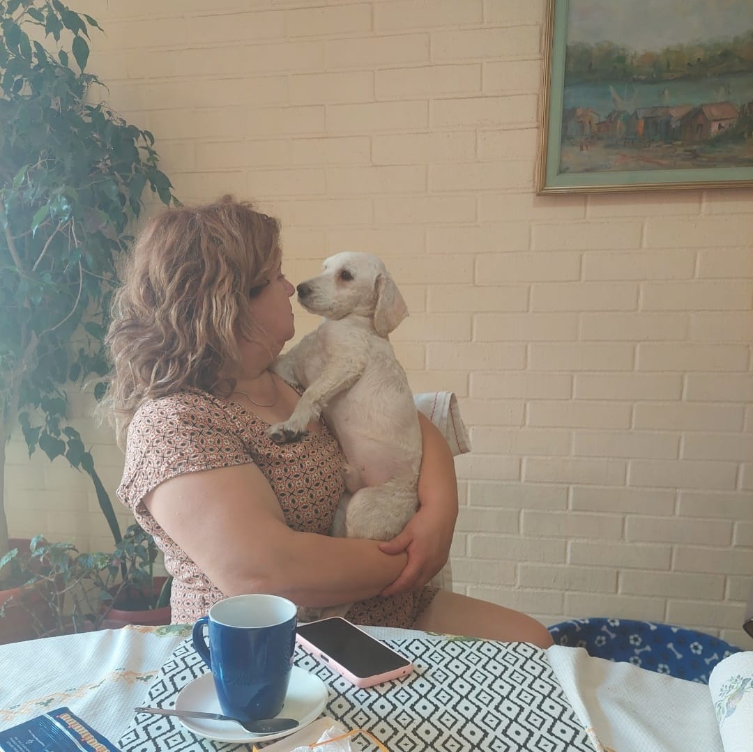 woman holding a puppy