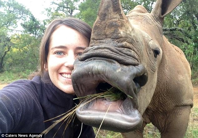 Mouthful: Jamie and Neni take a selfie as he eats grass