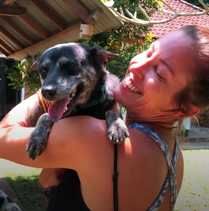 smiling woman holding dog