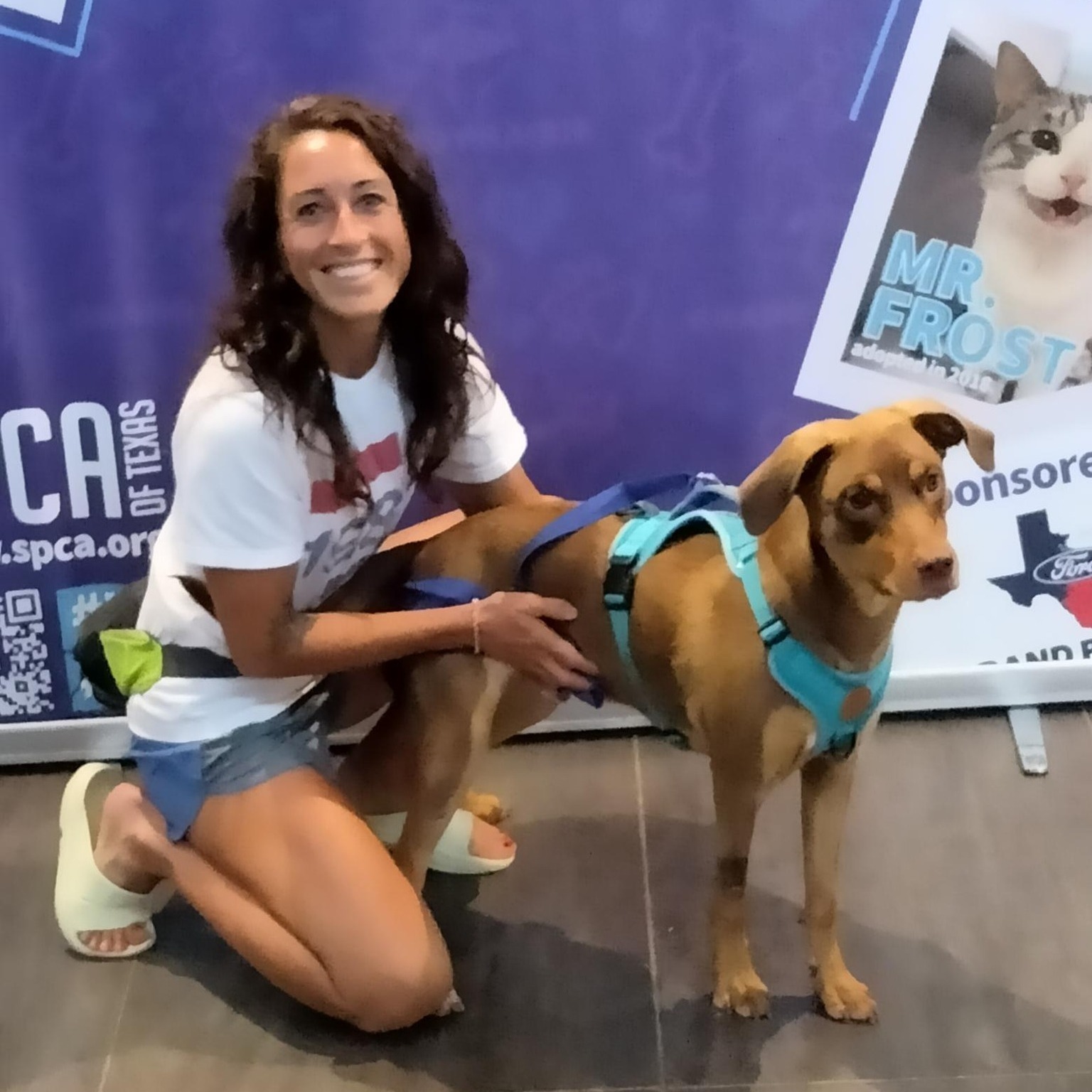 smiling woman posing with dog