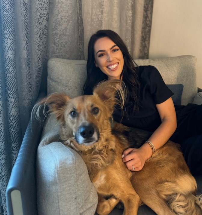 smiling woman with her timid dog