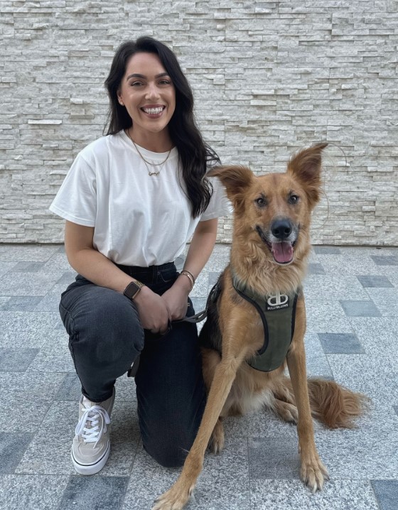 the dog poses with its owner